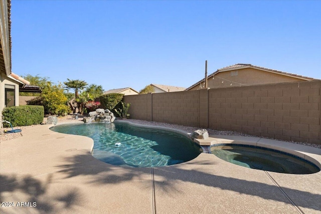 view of pool with an in ground hot tub