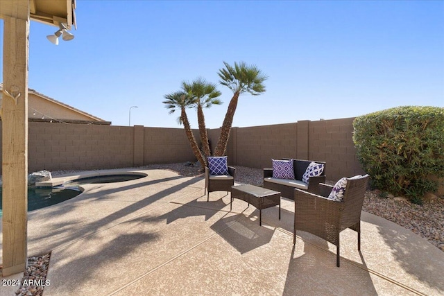 view of patio / terrace with a fenced in pool and an outdoor living space