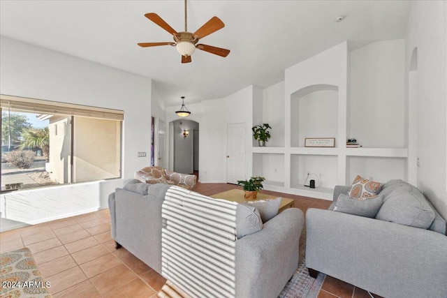 living room with light tile patterned floors, ceiling fan, and built in shelves