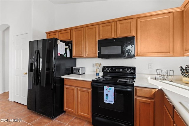 kitchen featuring light tile patterned floors and black appliances