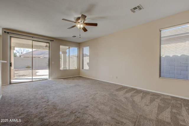 spare room featuring ceiling fan and carpet