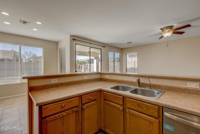 kitchen featuring sink, light tile patterned floors, stainless steel dishwasher, and ceiling fan