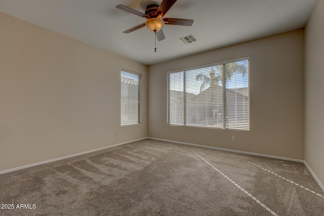 spare room with ceiling fan and light colored carpet