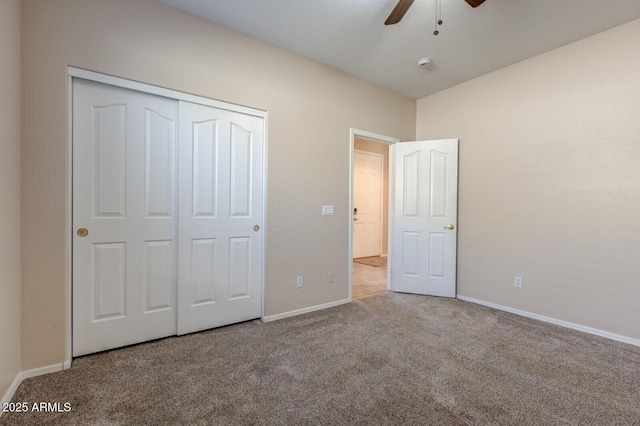 unfurnished bedroom with light carpet, a closet, and ceiling fan