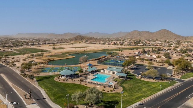 birds eye view of property with a water and mountain view