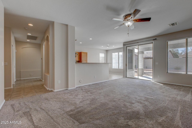 unfurnished living room with ceiling fan and light carpet