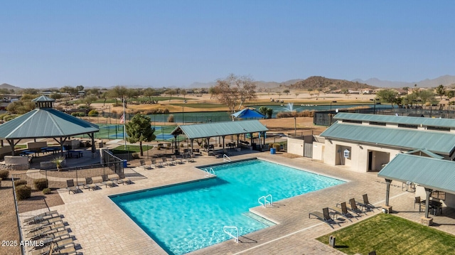 view of swimming pool with a gazebo, a mountain view, and a patio