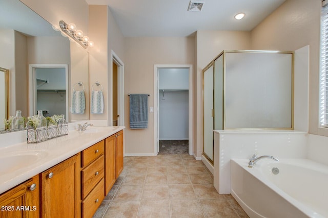 bathroom with tile patterned flooring, vanity, and separate shower and tub