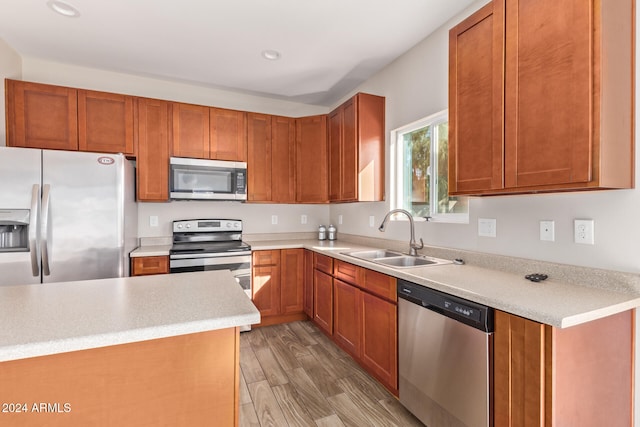 kitchen featuring sink, stainless steel appliances, and light hardwood / wood-style floors