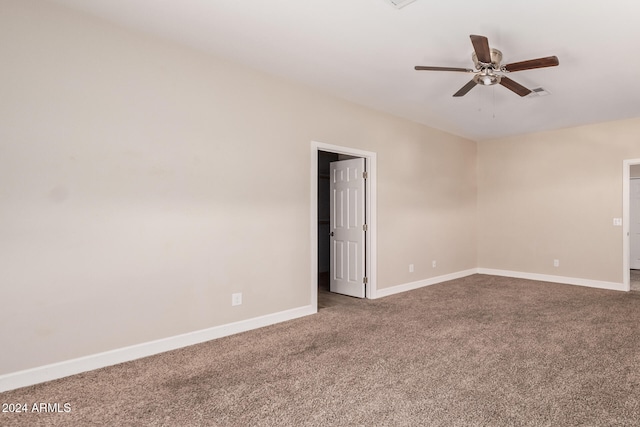 carpeted spare room featuring ceiling fan