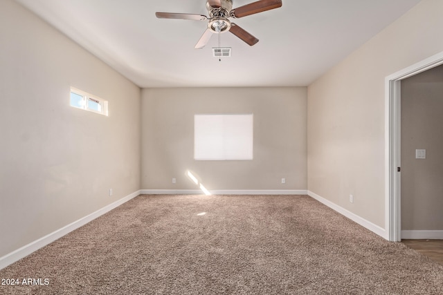 carpeted empty room featuring ceiling fan