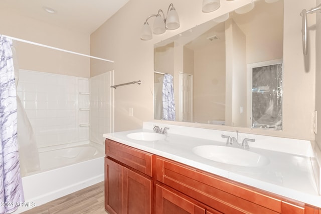 bathroom with vanity, hardwood / wood-style flooring, and shower / bath combo