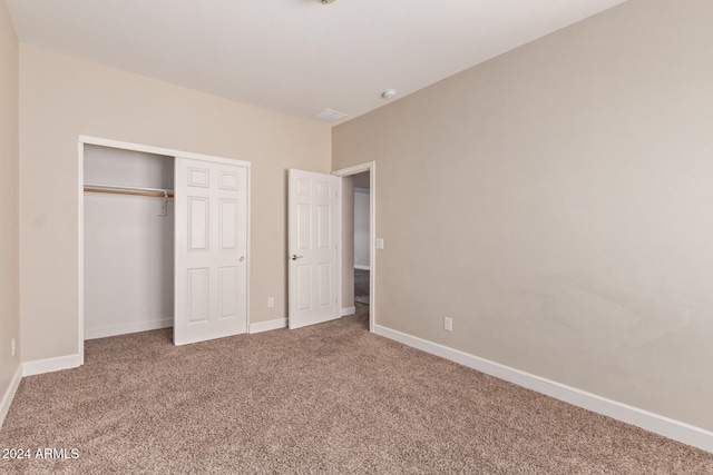 unfurnished bedroom with carpet floors and a closet