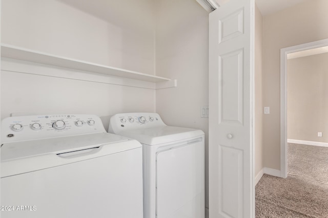 laundry room with carpet flooring and separate washer and dryer