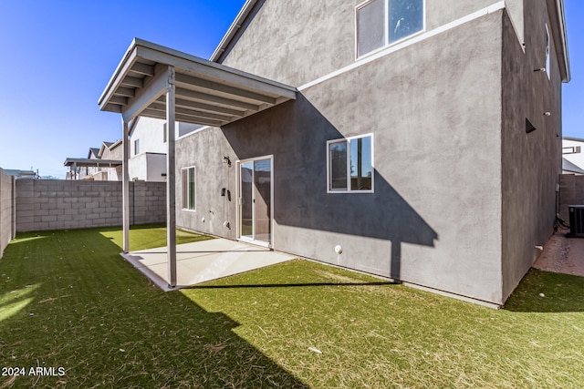 back of property featuring a patio area and a lawn