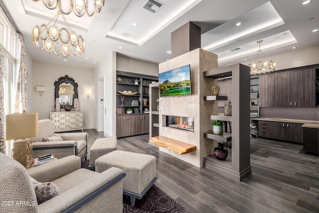 2001 N 1st Ave, Phoenix, AZ 85003 - living room featuring an inviting chandelier, a tiled fireplace, a tray ceiling, and dark hardwood / wood-style flooring