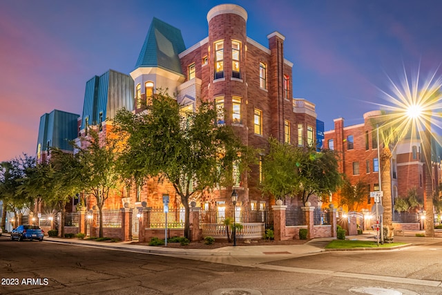 view of outdoor building at dusk