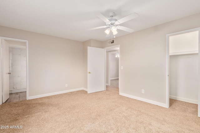 unfurnished bedroom with a closet, connected bathroom, and light carpet