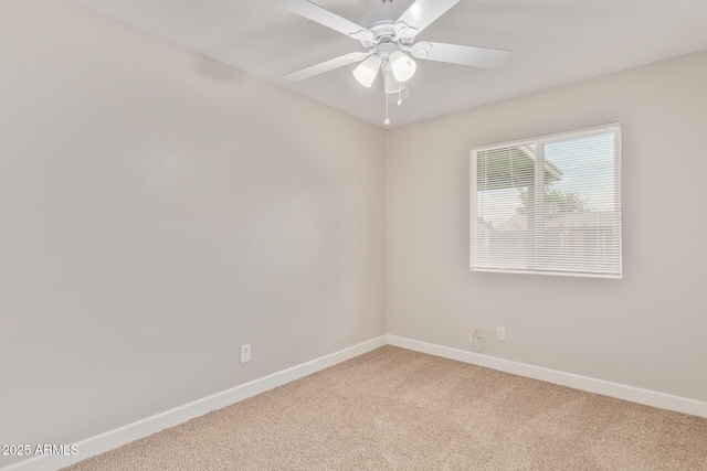 carpeted empty room featuring ceiling fan