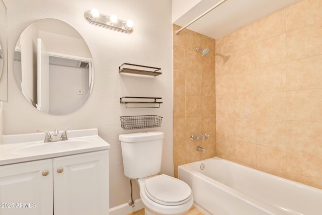 full bathroom with tiled shower / bath, vanity, and toilet