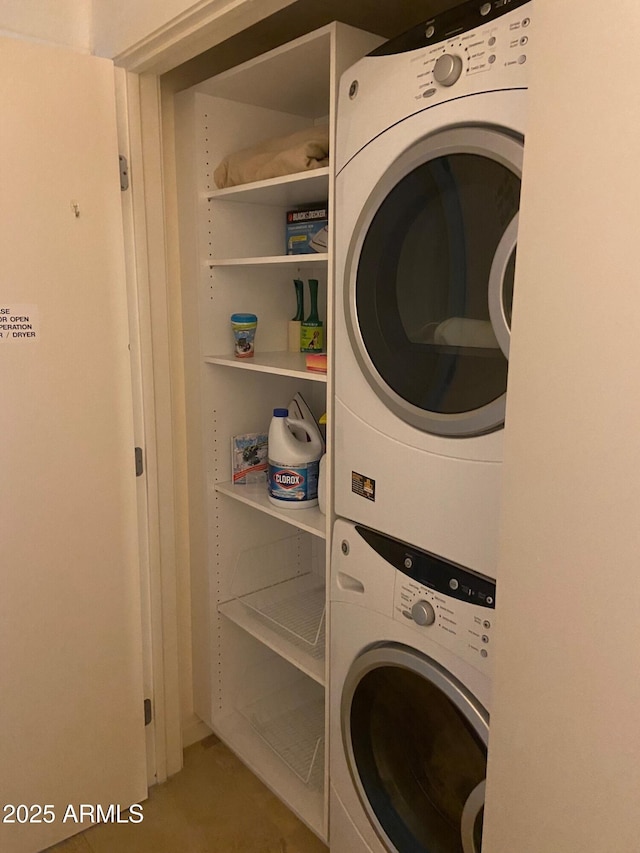 clothes washing area with laundry area and stacked washer and dryer
