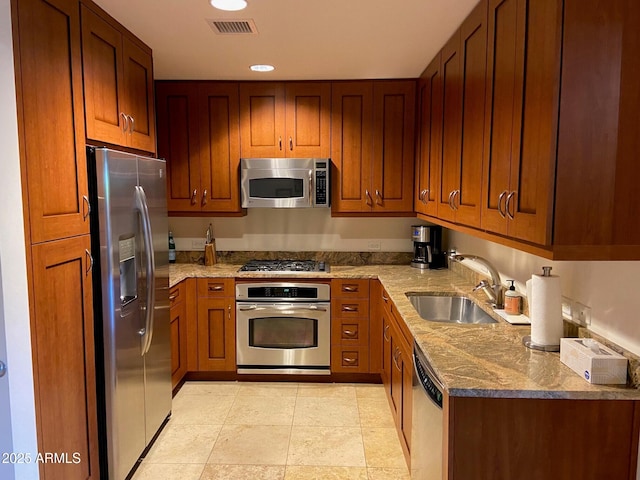 kitchen featuring visible vents, stone countertops, recessed lighting, a sink, and stainless steel appliances