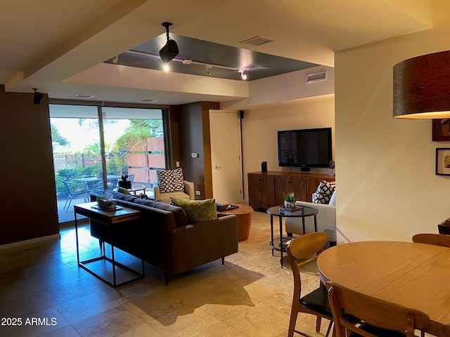 living area featuring visible vents, floor to ceiling windows, and track lighting