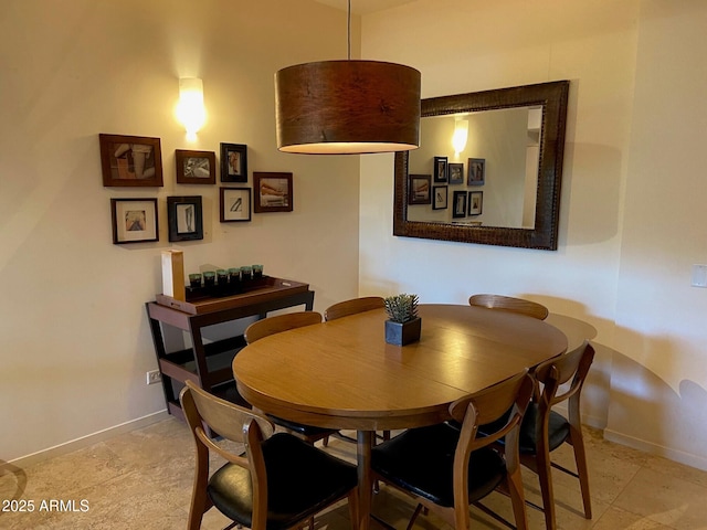 dining area featuring baseboards