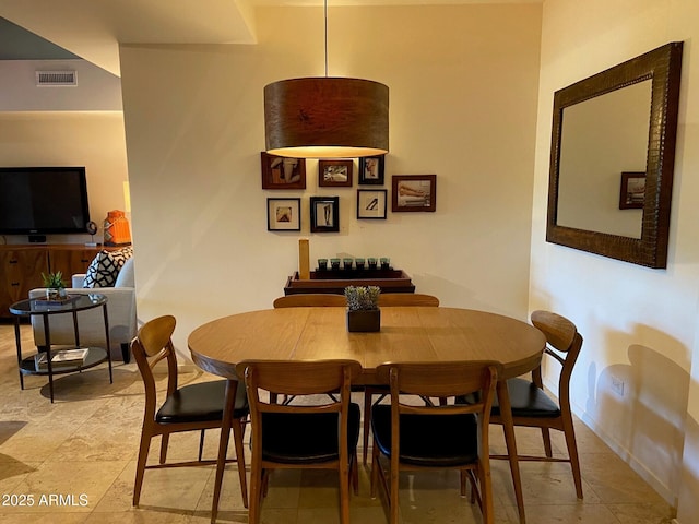 dining area with visible vents, stone finish flooring, and baseboards