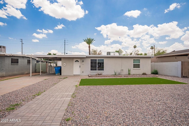 2205 W Cambridge Ave, Phoenix, AZ 85009 - view of front of house featuring stucco siding, an attached carport, and driveway