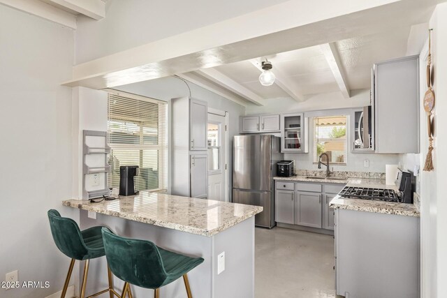 2205 W Cambridge Ave, Phoenix, AZ 85009 - kitchen with stainless steel appliances, a sink, beamed ceiling, finished concrete flooring, and light stone counters
