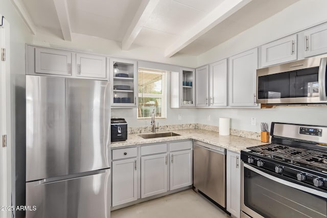 2205 W Cambridge Ave, Phoenix, AZ 85009 - kitchen with appliances with stainless steel finishes, a sink, beamed ceiling, light stone counters, and glass insert cabinets