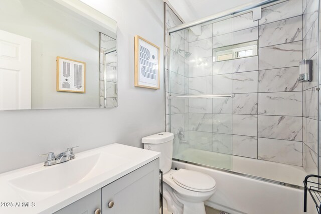 2205 W Cambridge Ave, Phoenix, AZ 85009 - bathroom featuring toilet, vanity, and enclosed tub / shower combo