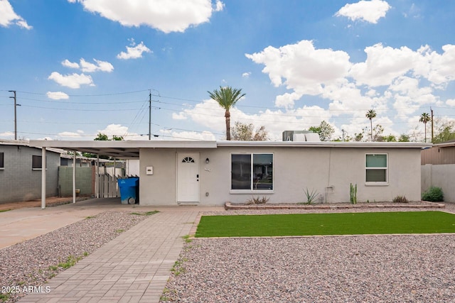 2205 W Cambridge Ave, Phoenix, AZ 85009 - ranch-style home with stucco siding, an attached carport, and driveway