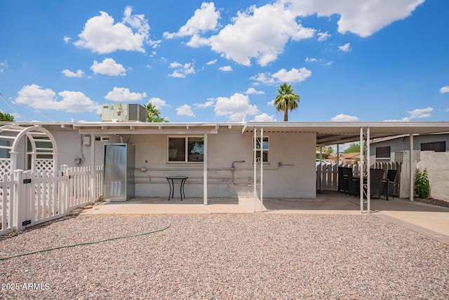 2205 W Cambridge Ave, Phoenix, AZ 85009 - back of property featuring stucco siding, a gate, a carport, and a patio area