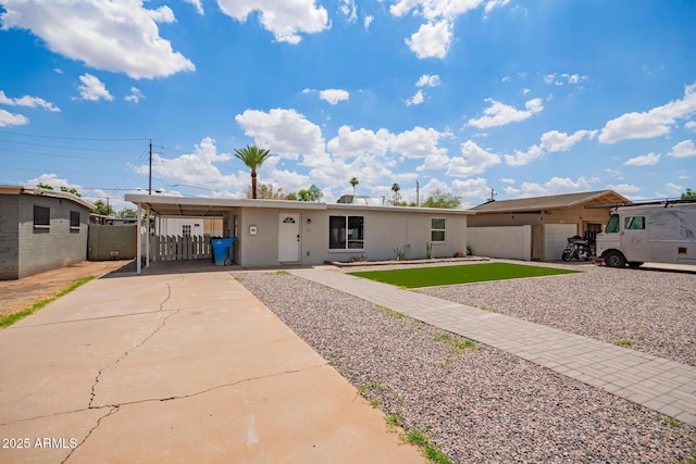 2205 W Cambridge Ave, Phoenix, AZ 85009 - view of front facade with concrete driveway, an attached carport, and stucco siding