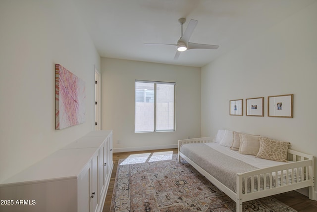 bedroom with wood finished floors, baseboards, and ceiling fan