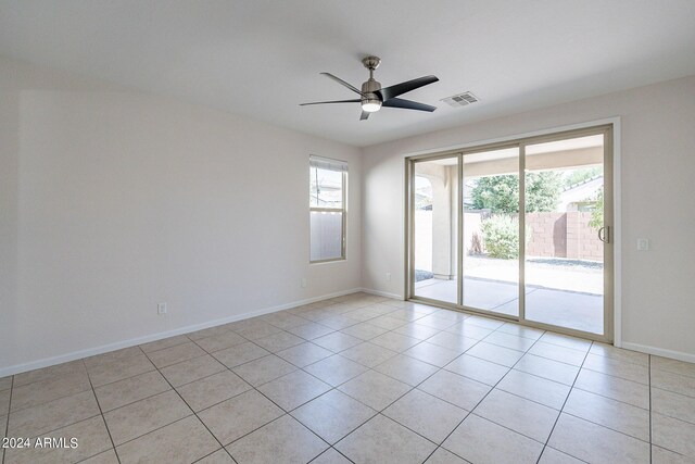 empty room featuring ceiling fan and light tile patterned floors