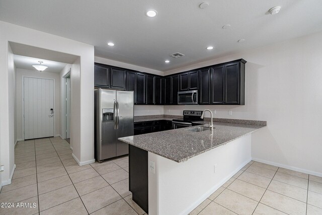 kitchen featuring sink, kitchen peninsula, and appliances with stainless steel finishes