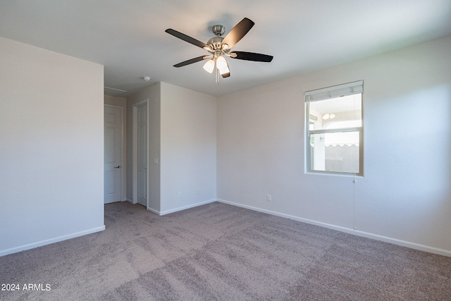 empty room featuring ceiling fan and light colored carpet