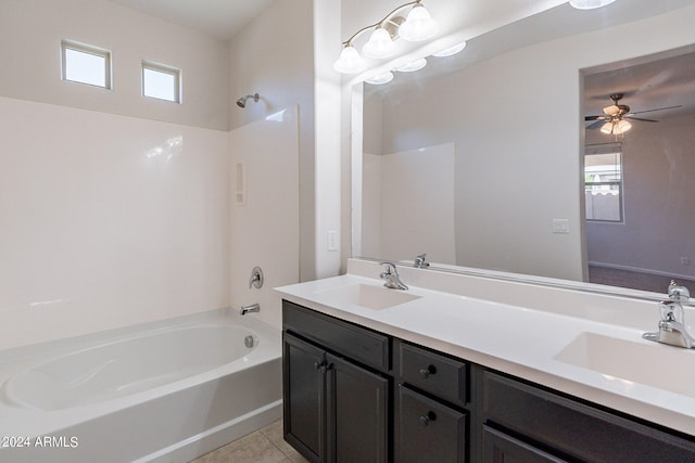 bathroom featuring a healthy amount of sunlight, double sink vanity, bathtub / shower combination, and tile patterned floors