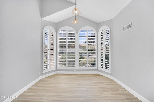 unfurnished dining area with visible vents, light wood-type flooring, and baseboards