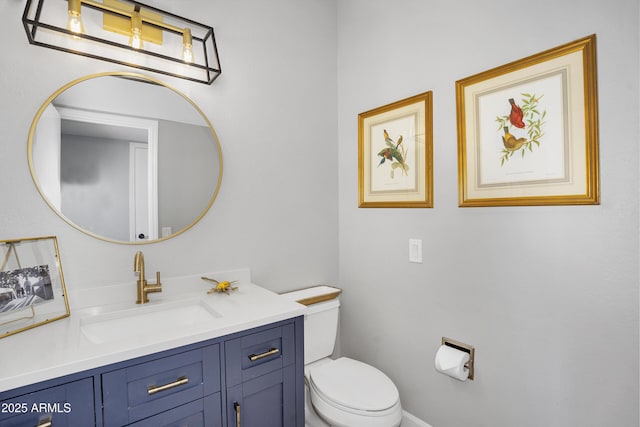 half bath featuring vanity and toilet