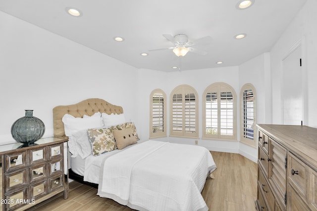 bedroom with ceiling fan, recessed lighting, light wood-style floors, and baseboards