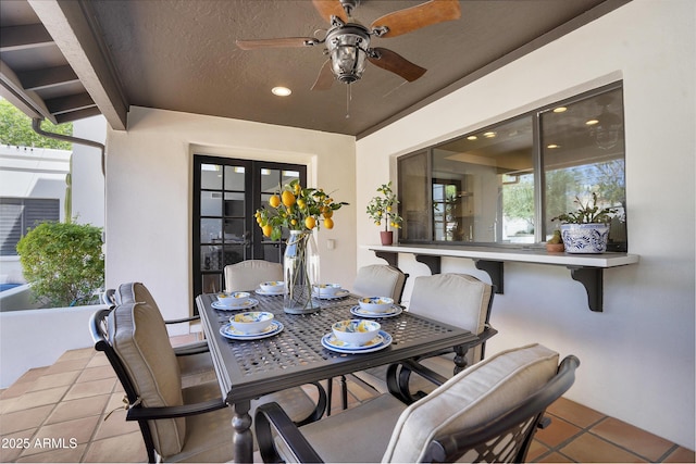 view of patio with outdoor dining space and a ceiling fan