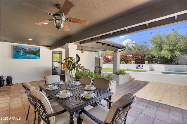 view of patio featuring fence and ceiling fan