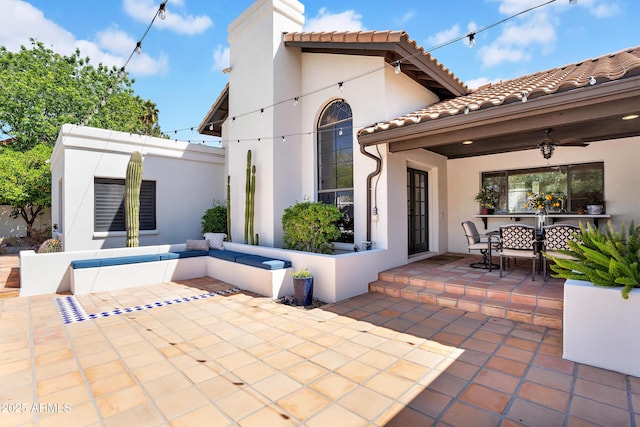 view of patio featuring ceiling fan