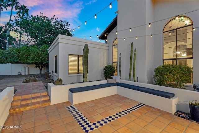 view of patio featuring an outbuilding and fence