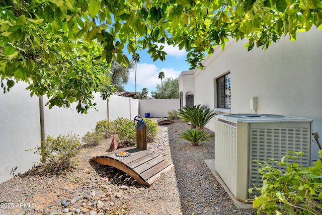 view of yard with central air condition unit and a fenced backyard