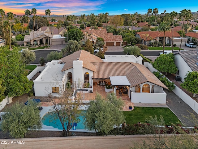 aerial view at dusk featuring a residential view